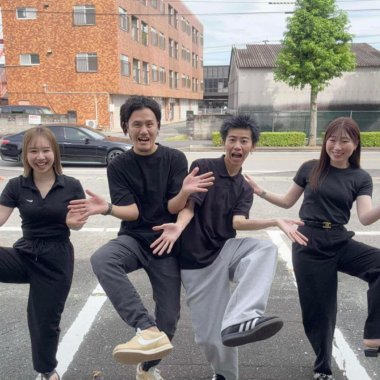 店の前でポーズするスタッフ4人